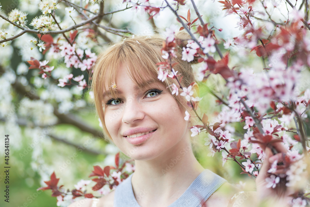 Beautiful young woman during spring flowering