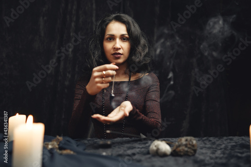 Portrait of fortune-teller in a dark room photo