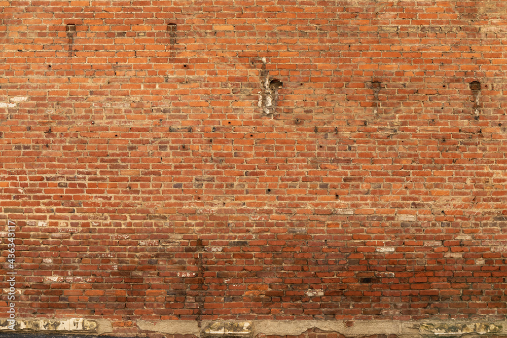 Background of expansive very old red brick wall, lower half needing to be repointed, horizontal aspect Background of expansive very old red brick wall, lower half needing to be repointed, horizontal aspect