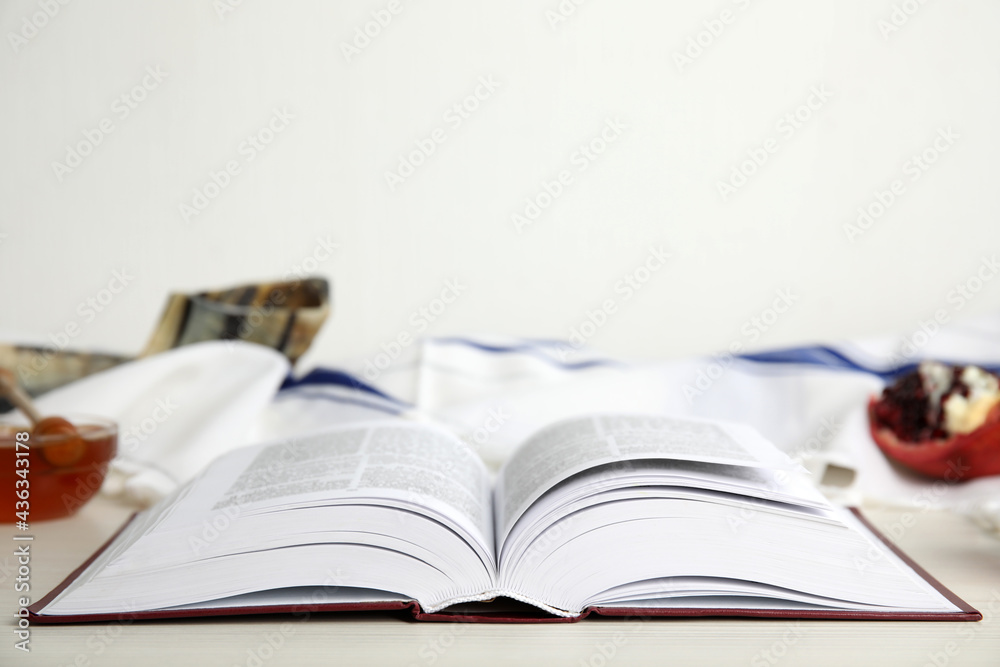 Open Torah on white wooden table, space for text. Rosh Hashanah celebration Open Torah on white wooden table, space for text. Rosh Hashanah celebration