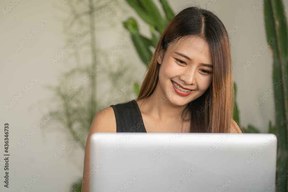 Head shot portrait of happy smiling Asian woman sitting at table Head shot portrait of happy smiling Asian woman sitting at table