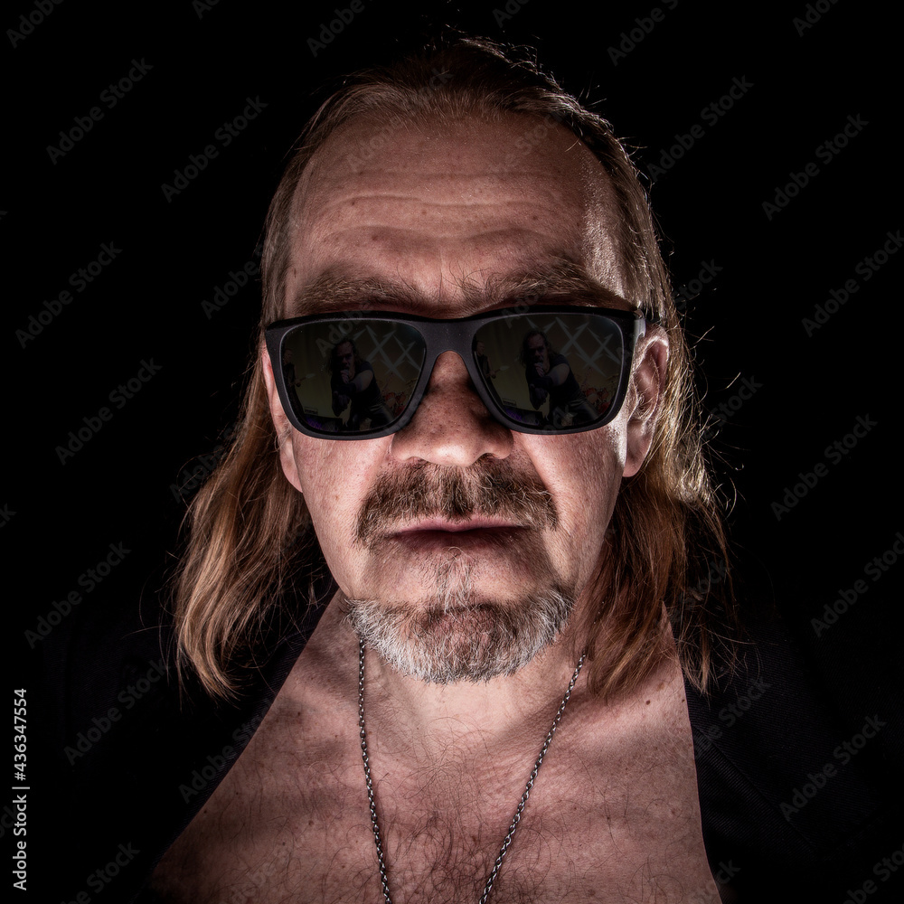 Portrait of a man in a jacket and sunglasses, rock. Portrait of a man in a jacket and sunglasses, rock.