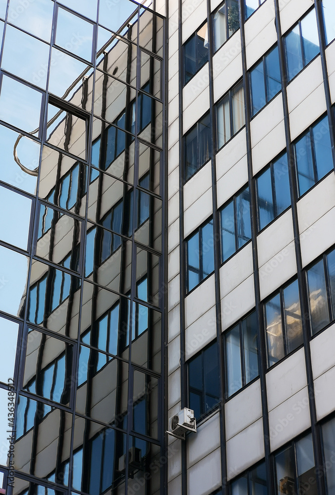 Looking up to facade of building reflecting in windows Looking up to facade of building reflecting in windows