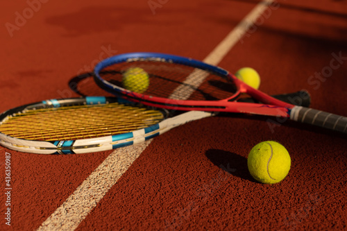 Close up view of two tennis rackets and balls on the tennis court. © Angelov