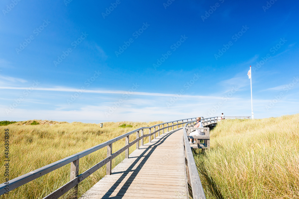 Two people on footpath in Westerland on Sylt. Two people on footpath in Westerland on Sylt.