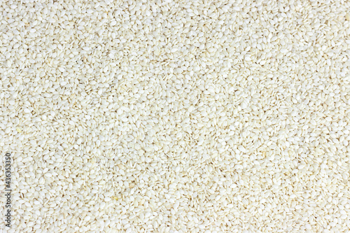 Top view of white sesame seeds texture as a food background.