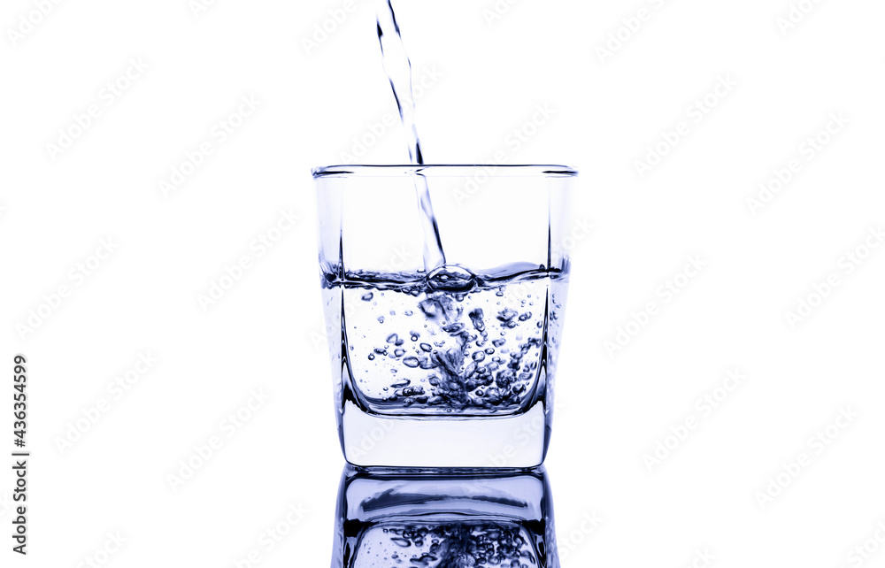 Pour water into a clear glass with a splash of water. Isolated on white background Pour water into a clear glass with a splash of water. Isolated on white background