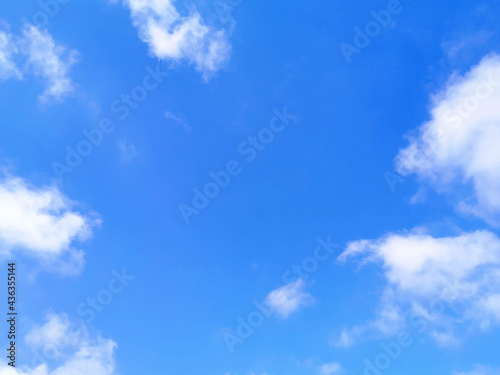 Blue sky with fluffy white clouds. Beautiful sky in the morning. Copy space is in the middle of photo. The concept of new life beginning, freedom of life, positive energy and peaceful mind. 