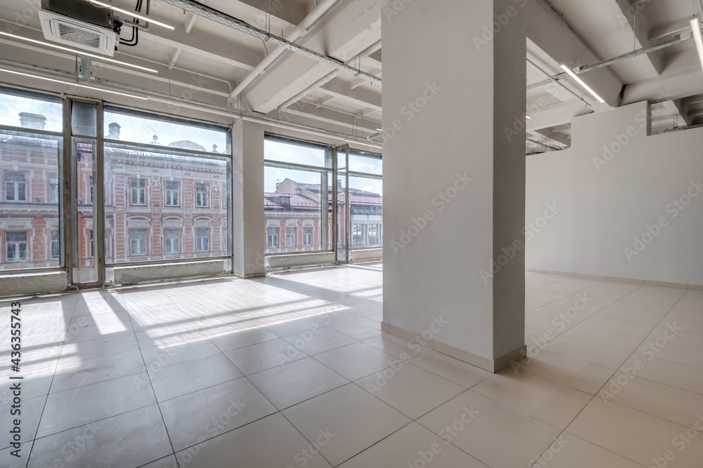Modern white empty room interior with columns and panoramic windows. room for office or store Modern white empty room interior with columns and panoramic windows. room for office or store