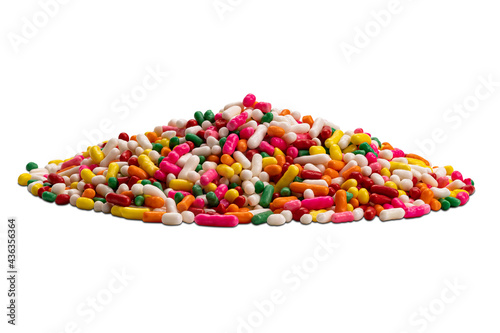 Side view closeup pile of colorful candy rainbow sprinkles isolated on white background with clipping path. photo