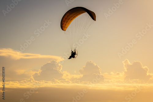 Paraglider fly in the sky above the sea. 