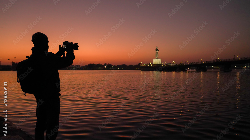 Silhouette of a photographer capturing the sunset in India, travel ...