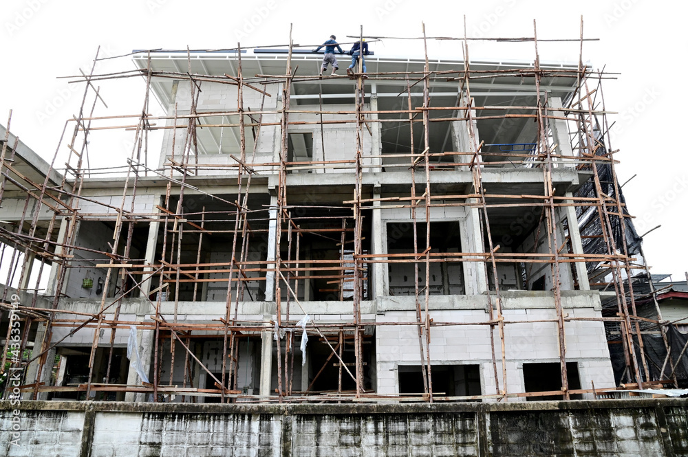 Group of Thai construction workers are helping to build a luxury home in construction site at Thailand.