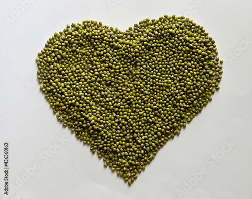 A pile of Fresh Mung Beans in the shape of a heart on the white background, Full depth of field.