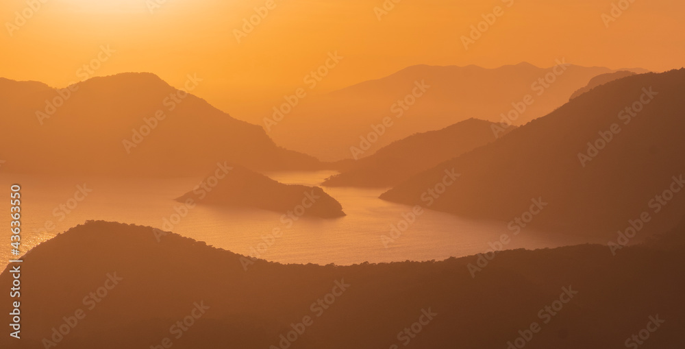 Beautiful Orange sunset over the blue lagoon of Oludeniz in Mugla province, fethiye in turkey Beautiful Orange sunset over the blue lagoon of Oludeniz in Mugla province, fethiye in turkey