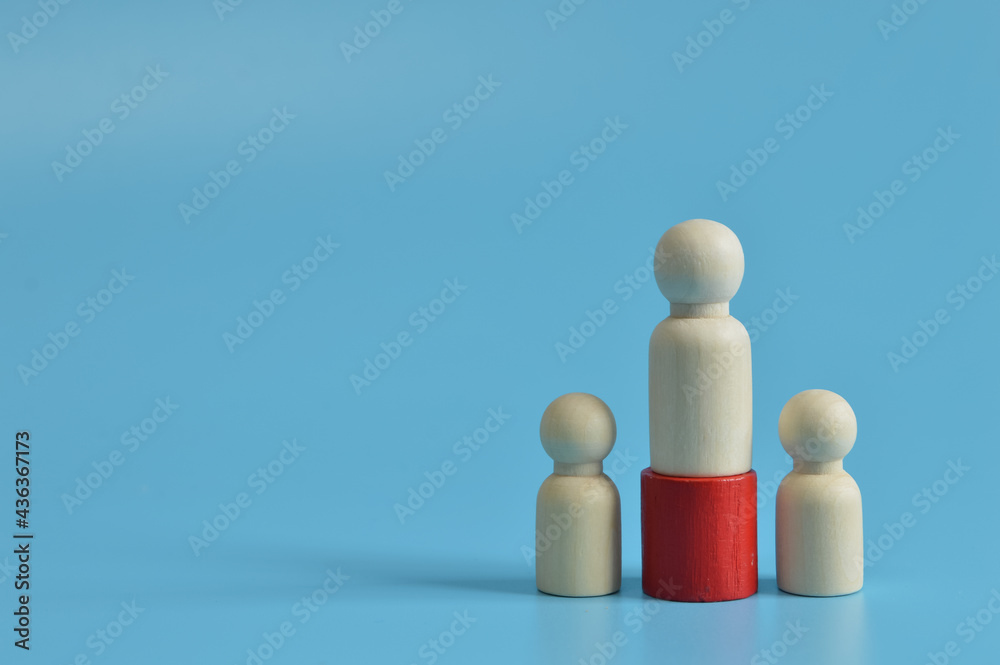 Wooden figures of people isolated on blue background. The concept of victory and business competition. Wooden figures of people isolated on blue background. The concept of victory and business competition.