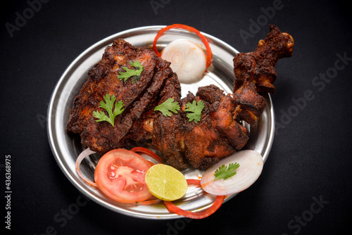 chicken tandoori in dish with salad