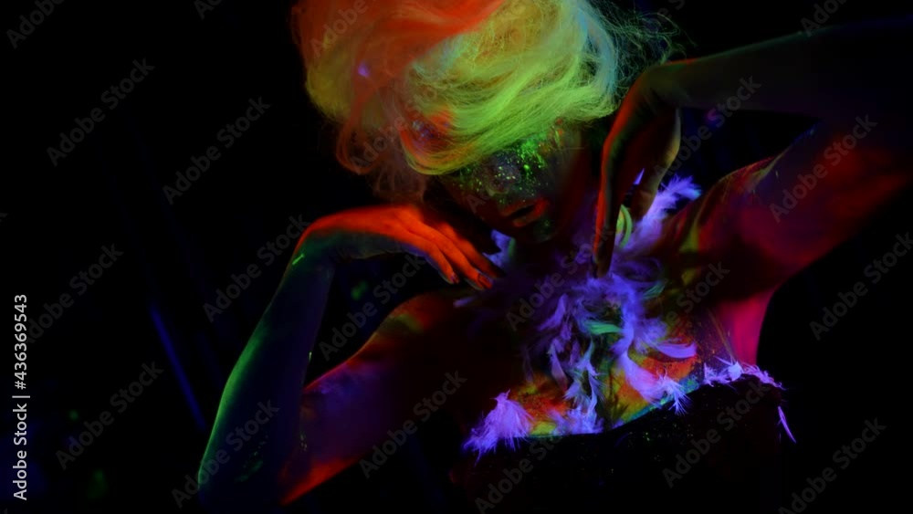 sexy lady is covered by fluorescent paints, amazing neon body art glowing in UV lights sexy lady is covered by fluorescent paints, amazing neon body art glowing in UV lights