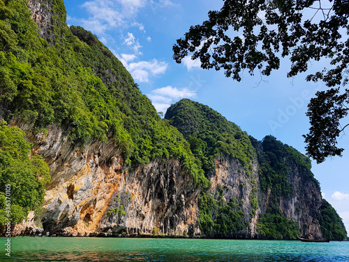 Mountains with trees against the background of sky and water