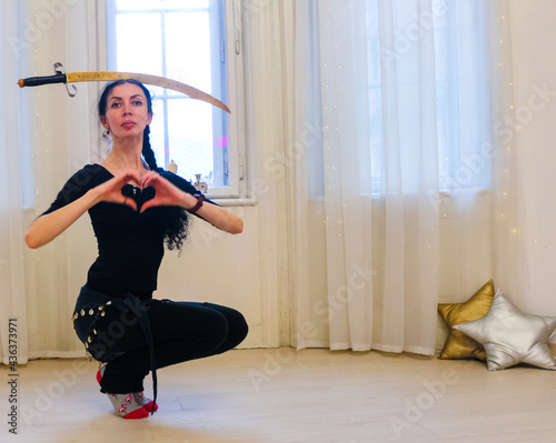 Fototapeta Naklejka Na Ścianę i Meble -  woman with sword in dance studio
