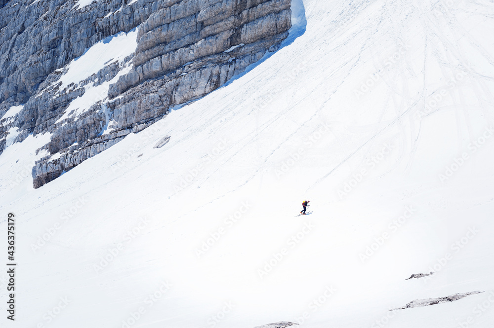 little skalpinist climbs a snowy 
mountainside slovenian alps Mala Mojstrovka