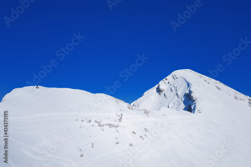 little skalpinist climbs a snowy  mountainside slovenian alps Mala Mojstrovka © Alevtina