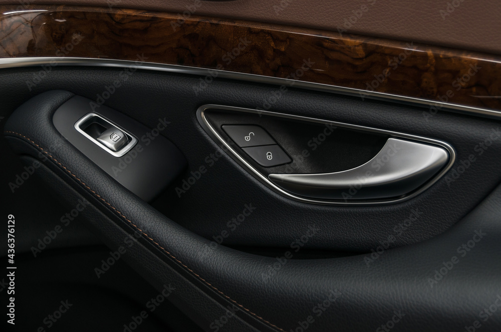 Car door handle with windows control buttons.