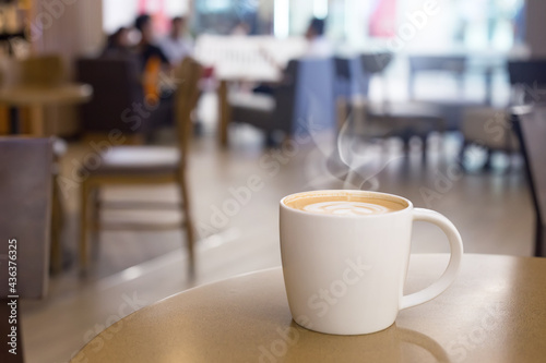 hot coffee cup with smoke on wood table in empty
