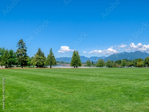 Green grass field of recreational stadium on bright sunny day