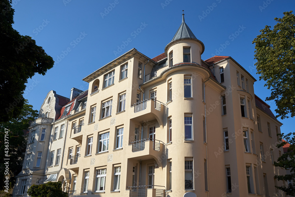 a historic tenement house with a tower