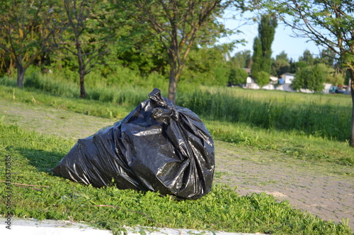 Garbage bags in nature. Garbage on the road.