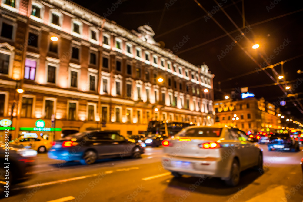 Nights lights of the big city, rush hour in the city. Wide-angle view, defocused image