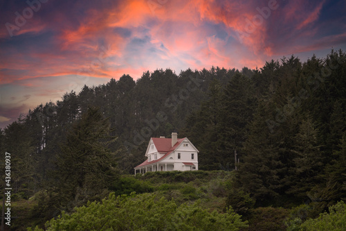Historic lighthouse keepers house at sunsetat Heceta Head near Cape Perpetua on the Oregon coast near Floresnce.