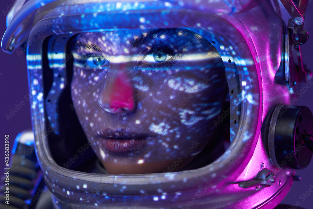 Portrait of female astronaut in studio with illumination