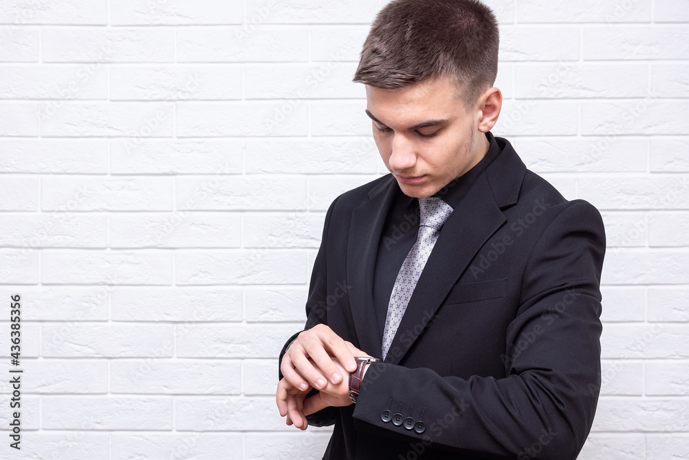 Male businessman on a white brick wall background Male businessman on a white brick wall background
