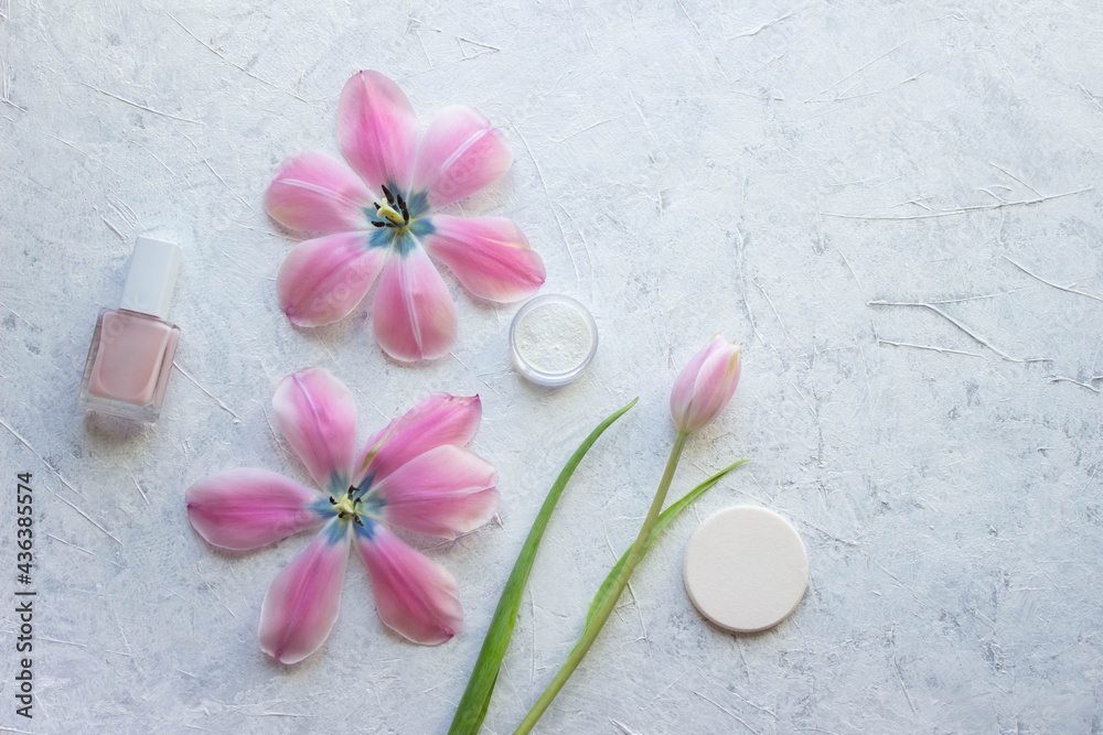 nail polish firming, sponge, tulips and a jar of powder stand on a light background, cosmetic minimalism nail polish firming, sponge, tulips and a jar of powder stand on a light background, cosmetic minimalism