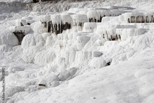 Close up of white limestone natural travertine terraces in pamukkale with pools full of carbonated water © Sergei Timofeev