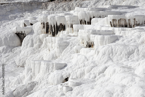 Close up of white limestone natural travertine terraces in pamukkale with pools full of carbonated water