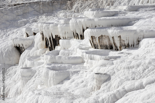 Close up of white limestone natural travertine terraces in pamukkale with pools full of carbonated water © Sergei Timofeev