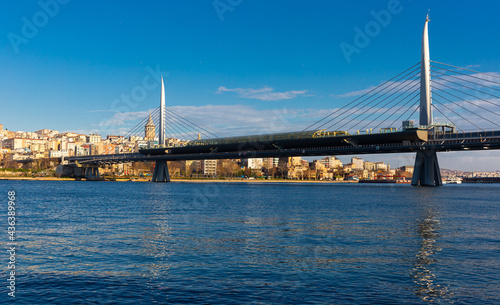 View of Golden Horn bay with cable-stayed metro bridge connecting Beyoglu and Fatih districts on sunny winter day, Istanbul, Turkey