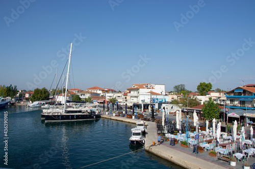 Boats at the port of village of Keramoti  Greece. Thasos island harbor  beautiful blue water and sky  tavernas  caf   and restaurants  travel destination
