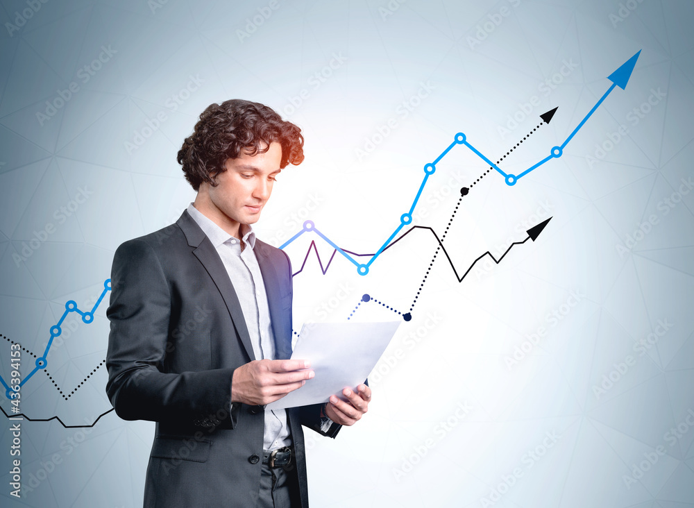 Businessman with paper document standing near rising stock market lines Businessman with paper document standing near rising stock market lines