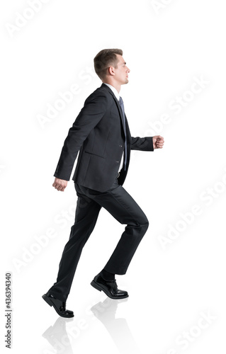 Young businessman climbing career ladder, isolated, side view © ImageFlow