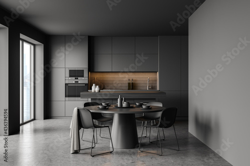 Grey kitchen interior with round dining table photo