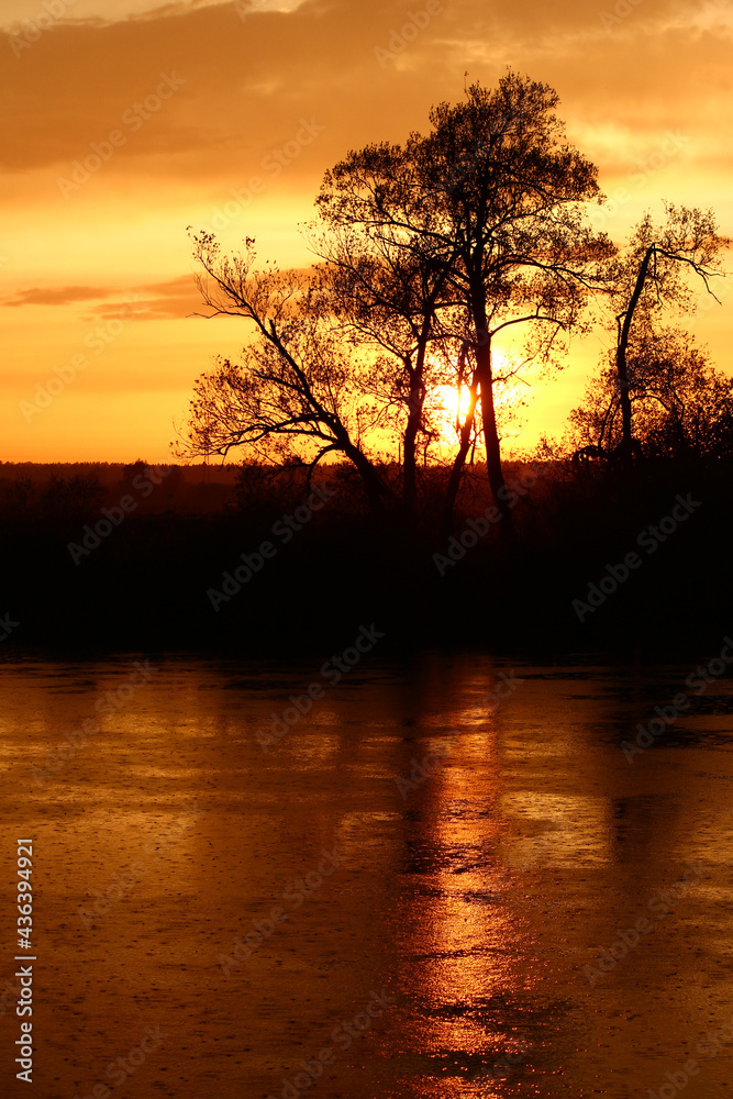 Colorful sunset over a pond during rain Colorful sunset over a pond during rain