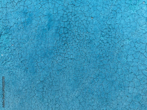 peeling blue paint on wooden background