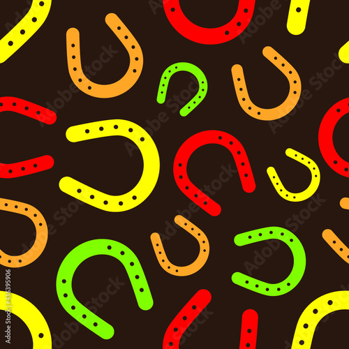 Colorful horseshoe seamless pattern on brown background. Vector illustration.
