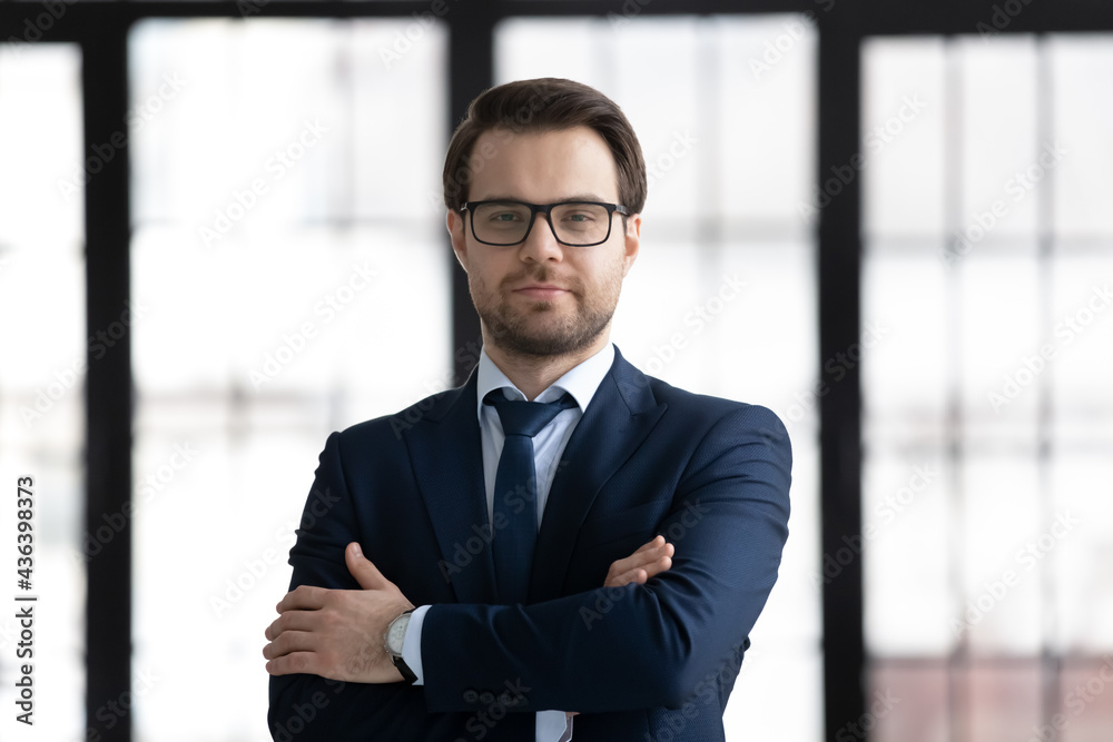 Successful business leader portrait. Confident young 30s businessman headshot. Professional, CEO, executive in glasses and formal suit looking at camera with arms folded. Leadership, success concept Successful business leader portrait. Confident young 30s businessman headshot. Professional, CEO, executive in glasses and formal suit looking at camera with arms folded. Leadership, success concept
