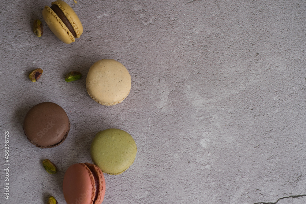 Colorful macarons and pistachios isolated. French meringue cookie macaron. Colorful macarons and pistachios isolated. French meringue cookie macaron.