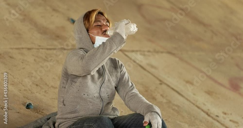 Homeless man drinking water